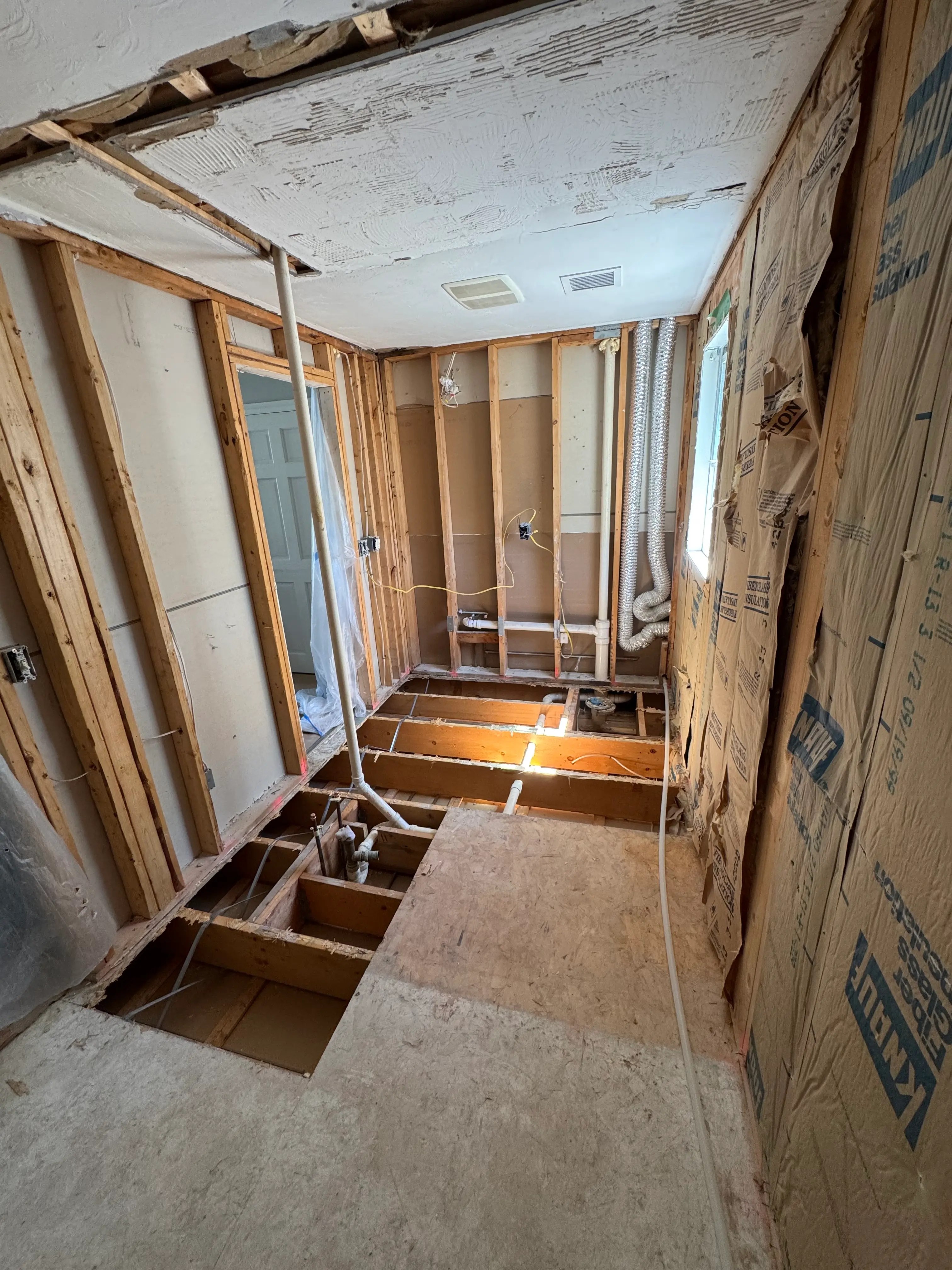 Bathroom opened to framing during demolition and preparation