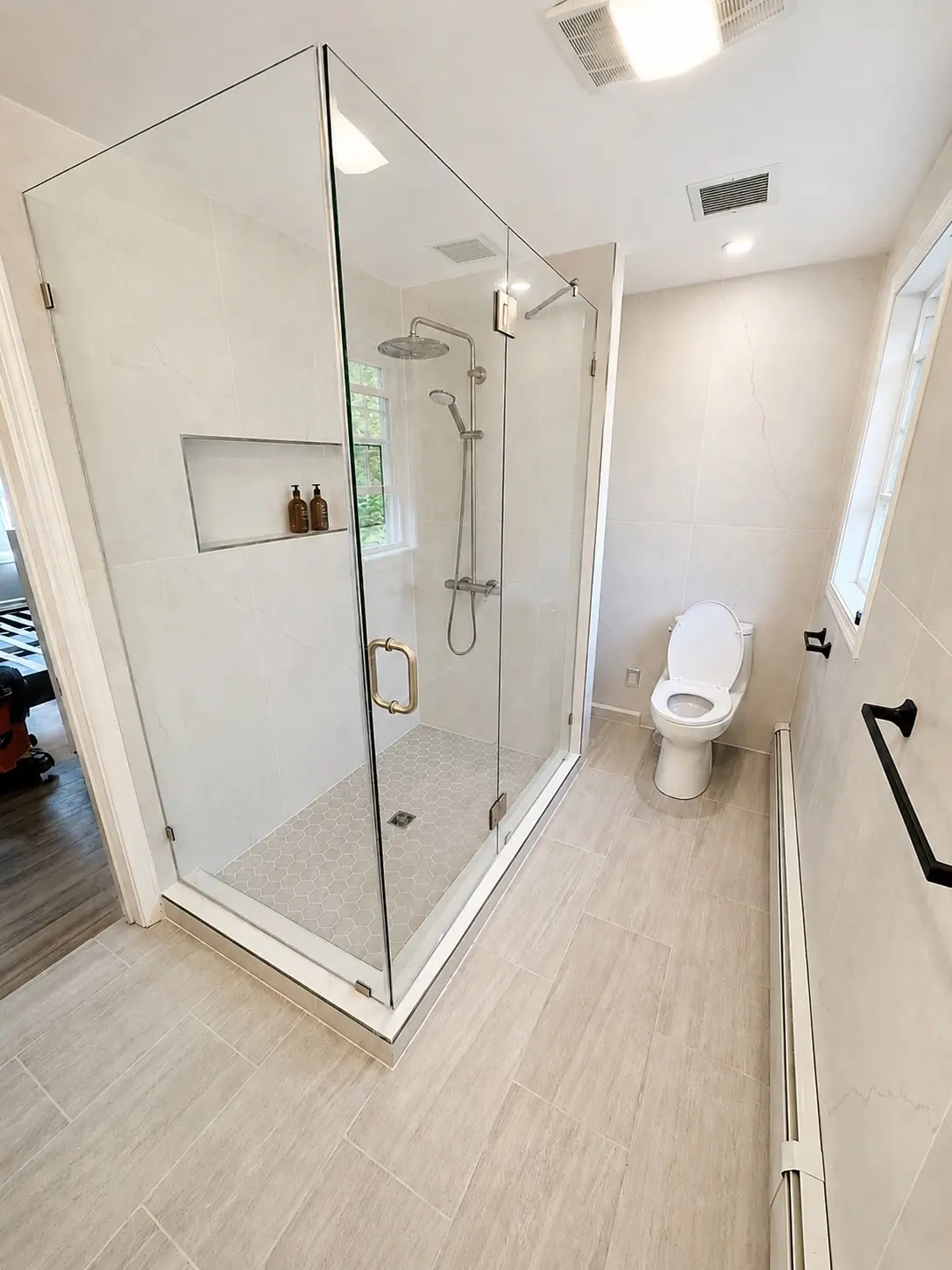 Completed bathroom remodel with fixtures and glass shower enclosure