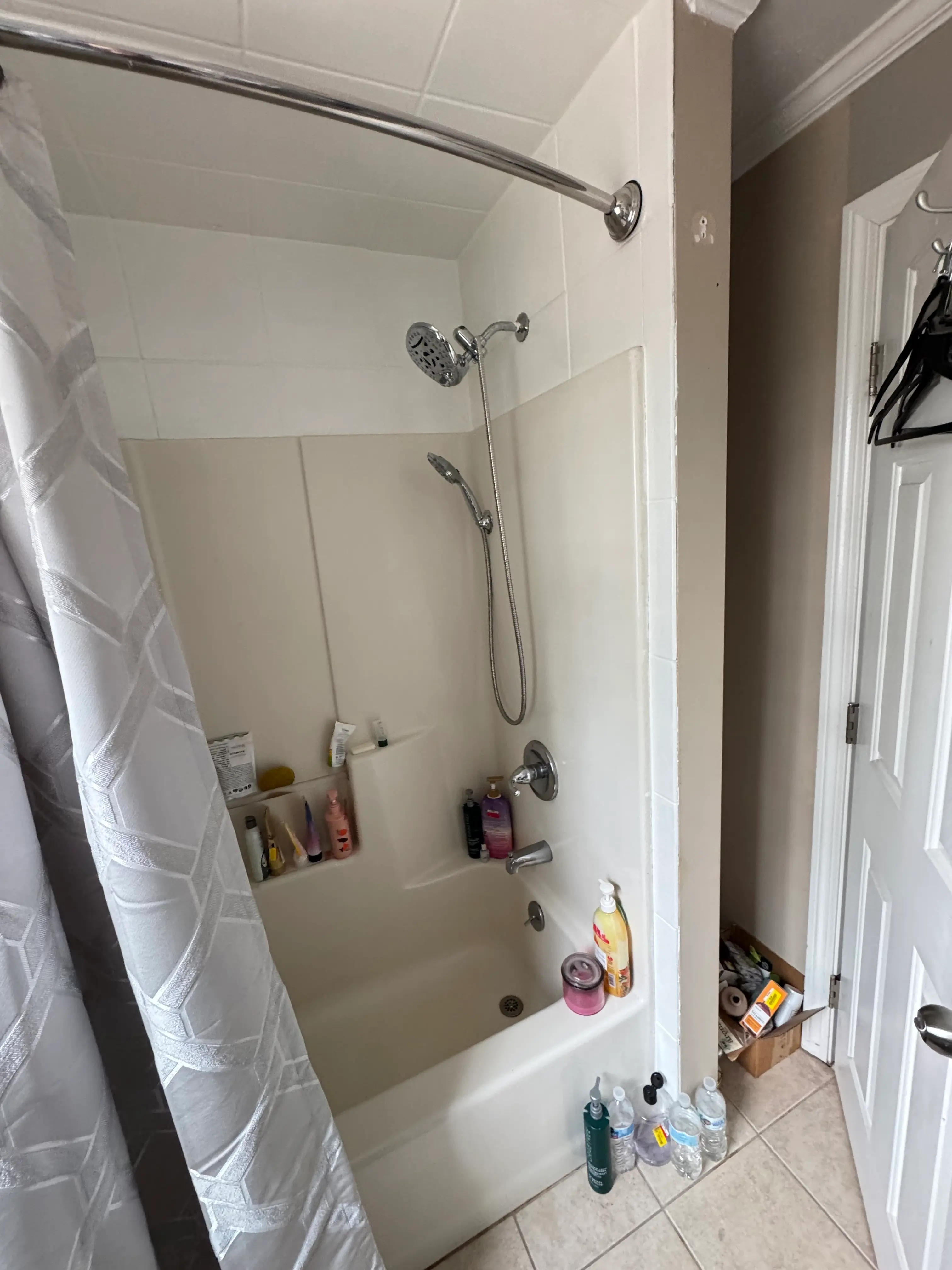 Existing tiled tub and shower area before remodeling work begins